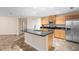 Kitchen with stainless steel appliances, granite countertops and tile floors at 305 Grande Lake Dr, Daytona Beach, FL 32124