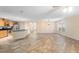 Open concept living room featuring tile floors, neutral walls, and a modern light fixture at 305 Grande Lake Dr, Daytona Beach, FL 32124