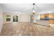 Bright, open-concept living room featuring tile flooring, and kitchen with breakfast bar at 305 Grande Lake Dr, Daytona Beach, FL 32124