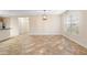Living room featuring tile floors, large window, and modern light fixture at 305 Grande Lake Dr, Daytona Beach, FL 32124