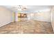 Bright, open-concept living room featuring tile flooring, and kitchen with breakfast bar at 305 Grande Lake Dr, Daytona Beach, FL 32124
