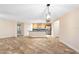 Bright, open-concept living room featuring tile flooring, and kitchen with breakfast bar at 305 Grande Lake Dr, Daytona Beach, FL 32124