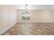Living room featuring tile floors, a modern light fixture, and large window at 305 Grande Lake Dr, Daytona Beach, FL 32124