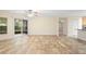 Bright living room with tile floors, ceiling fan, and sliding glass doors to lanai at 305 Grande Lake Dr, Daytona Beach, FL 32124