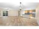 Bright, open-concept living room featuring tile flooring, and kitchen with breakfast bar at 305 Grande Lake Dr, Daytona Beach, FL 32124