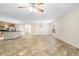 Bright, open-concept living room featuring tile flooring, and kitchen with breakfast bar at 305 Grande Lake Dr, Daytona Beach, FL 32124