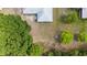 Aerial shot showcases a residential property's roof, expansive backyard, and surrounding natural tree landscape at 313 Greenwich Ct, Kissimmee, FL 34758
