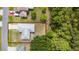 Aerial view of a single-Gathering home, offering a clear view of the roof and surrounding wooded area at 313 Greenwich Ct, Kissimmee, FL 34758