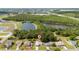 Aerial shot of a home next to a pond and wooded area, near residential community at 313 Greenwich Ct, Kissimmee, FL 34758