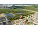 An aerial shot reveals a cozy home near a pond and surrounded by a verdant expanse of trees at 313 Greenwich Ct, Kissimmee, FL 34758