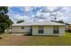 Spacious backyard view featuring the property's exterior, well-maintained lawn and beautiful landscaping at 313 Greenwich Ct, Kissimmee, FL 34758