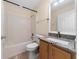 Bathroom featuring a shower-tub combo, tile flooring, granite countertop, and updated hardware at 313 Greenwich Ct, Kissimmee, FL 34758