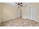 Inviting bedroom with tile flooring, double door closet, ceiling fan and convenient access to the rest of the home at 313 Greenwich Ct, Kissimmee, FL 34758