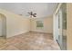 Sunlit bedroom showcasing tile floors, a ceiling fan, and a sliding glass door for seamless outdoor access at 313 Greenwich Ct, Kissimmee, FL 34758