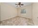 Cozy bedroom with tile floors, a ceiling fan, and a window offering natural light and backyard views at 313 Greenwich Ct, Kissimmee, FL 34758