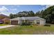 A well-maintained single-story home with lush green lawn, attached garage, and cozy front entrance at 313 Greenwich Ct, Kissimmee, FL 34758