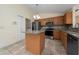 Well-lit kitchen featuring a center island, granite countertops, stainless steel appliances, and a tile backsplash at 313 Greenwich Ct, Kissimmee, FL 34758