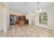 Bright kitchen with wooden cabinets, stainless steel appliances, an island, and tiled floors at 313 Greenwich Ct, Kissimmee, FL 34758