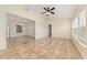 Open living space with tile flooring, neutral walls, and an adjacent dining area and hallway at 313 Greenwich Ct, Kissimmee, FL 34758
