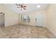 Inviting living room with neutral paint, tile flooring, ceiling fan, and ample natural light at 313 Greenwich Ct, Kissimmee, FL 34758