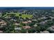 Expansive aerial view of luxury homes nestled among mature trees in a golf course community at 31754 Red Tail Blvd, Sorrento, FL 32776