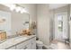 Well-lit bathroom featuring granite countertops, a large mirror, and a glass-enclosed shower at 31754 Red Tail Blvd, Sorrento, FL 32776