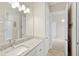 Stylish bathroom featuring sleek granite counters, modern fixtures, and access to the main bedroom at 31754 Red Tail Blvd, Sorrento, FL 32776