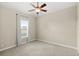 Cozy bedroom with a ceiling fan, neutral paint, plush carpet, and a window with peaceful views at 31754 Red Tail Blvd, Sorrento, FL 32776