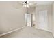 Spacious bedroom with carpet and ceiling fan, complemented by views of other areas of the house at 31754 Red Tail Blvd, Sorrento, FL 32776