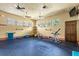 Spacious gym area with fitness equipment, ceiling fans, and ample natural light from surrounding windows at 31754 Red Tail Blvd, Sorrento, FL 32776