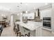 Spacious kitchen with white cabinetry, a large granite island, and stainless steel appliances at 31754 Red Tail Blvd, Sorrento, FL 32776