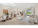 Bright, open-concept living area with elegant furnishings, tile floors, and access to the outdoor patio at 31754 Red Tail Blvd, Sorrento, FL 32776