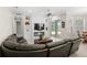 Comfortable living room featuring a cozy sofa, modern fireplace, and a sliding glass door leading to the outdoor space at 31754 Red Tail Blvd, Sorrento, FL 32776