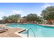 Community pool area featuring a pool, lounge chairs, and tables with umbrellas at 31754 Red Tail Blvd, Sorrento, FL 32776