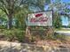 Community sign nestled among trees at 31754 Red Tail Blvd, Sorrento, FL 32776