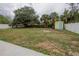 Large backyard with trees, shed, and white fence, perfect for outdoor activities and privacy at 3300 Needles Dr, Orlando, FL 32810