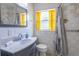 Classic bathroom with bright yellow curtains, marble countertop, and a shower with patterned curtain at 3300 Needles Dr, Orlando, FL 32810