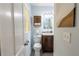Bathroom showcasing a toilet, sink with vanity, and decorative accents for a well-coordinated look at 3300 Needles Dr, Orlando, FL 32810