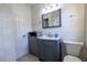 This bathroom features a toilet, a sink with vanity, and a mirror, offering practicality and style at 3300 Needles Dr, Orlando, FL 32810