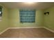 The bonus room features light green walls, tile flooring, and a window with colorful curtains at 3300 Needles Dr, Orlando, FL 32810