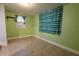 Inviting bonus room featuring light green walls, tile flooring, and a window with bright curtains at 3300 Needles Dr, Orlando, FL 32810