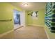 Bright bonus room featuring light green walls, tile flooring, and a view of the modern kitchen at 3300 Needles Dr, Orlando, FL 32810