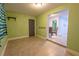 Bonus room with light green walls, tile flooring, and an open doorway to another room in the home at 3300 Needles Dr, Orlando, FL 32810
