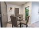 Cozy dining area with a glass table and upholstered chairs, adjacent to a sliding barn door and neutral decor at 3300 Needles Dr, Orlando, FL 32810