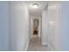 Bright hallway with tile flooring, leading to other rooms in the home, with storage on the right at 3300 Needles Dr, Orlando, FL 32810