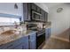 Modern kitchen with granite countertops, tile backsplash, and stainless steel appliances at 3300 Needles Dr, Orlando, FL 32810