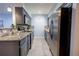 This kitchen features stainless steel appliances, granite countertops, and gray cabinets at 3300 Needles Dr, Orlando, FL 32810