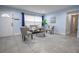 A lovely living room featuring tile floors, a gray couch, two chairs, and a large front window at 3300 Needles Dr, Orlando, FL 32810