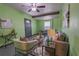 This cozy living room features green walls, exposed wood beams, and comfortable seating at 3300 Needles Dr, Orlando, FL 32810