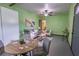 The living room is bright, featuring green walls, a ceiling fan, and access to the dining area at 3300 Needles Dr, Orlando, FL 32810